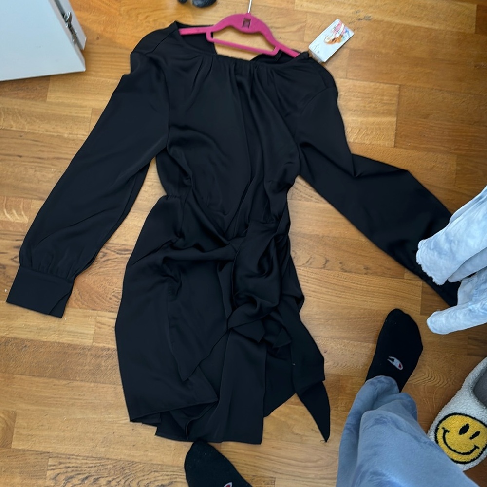 Tags on black long sleeve dress